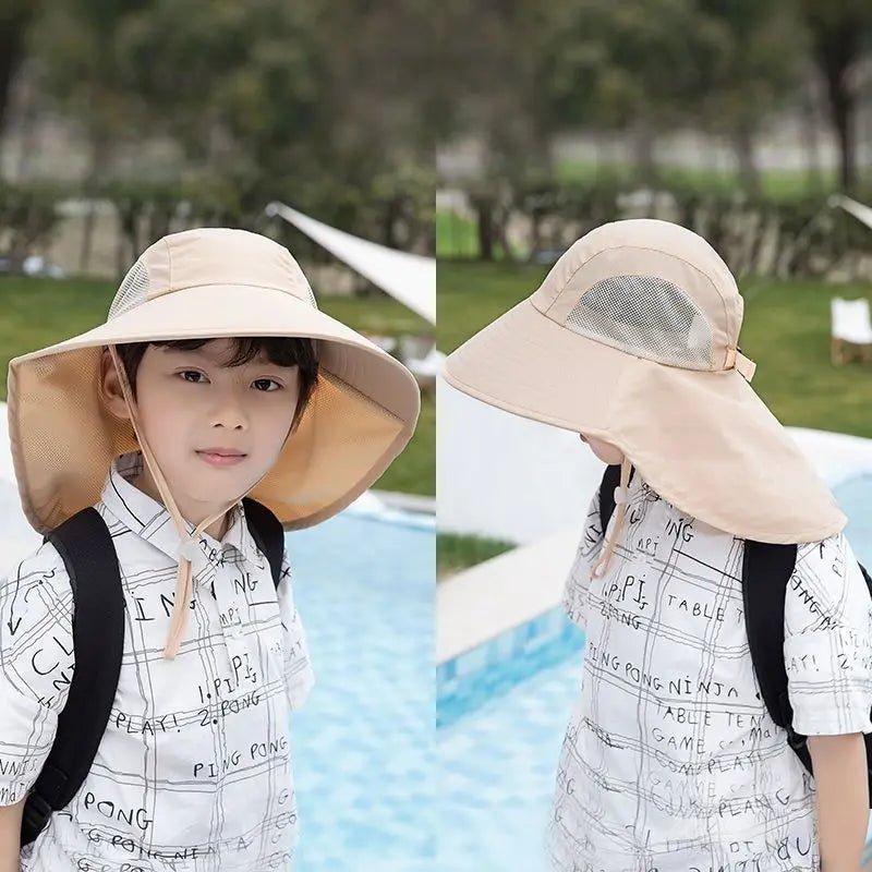 Child wearing a large beige sun hat by a poolside with trees in the background
