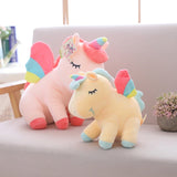 Two colorful unicorn plush toys on a couch with a blurred background