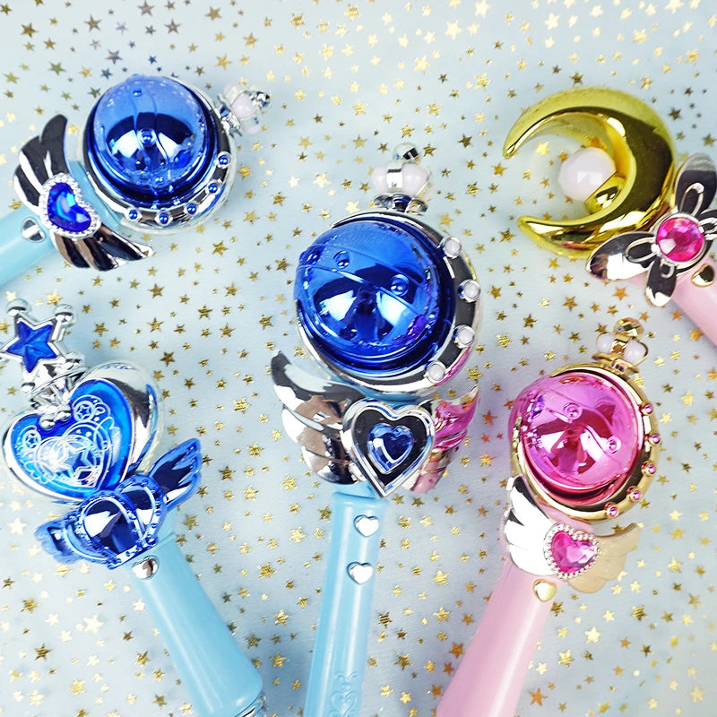 Blue and gold moon, heart and wing-shaped wands on a sparkly star background