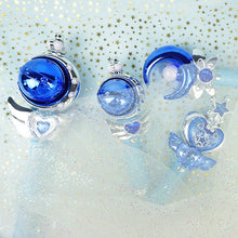 Blue orb and crystal wands on a glittery pale background