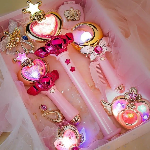 Glowing heart, moon and star-shaped magic wands with colorful lights lying in a pink gift box