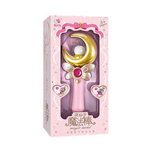 Pink window box holding a wand with a gold crescent moon and a red gem