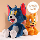 Two plush toys, one blue and one orange, resembling cartoon characters on a beige background.