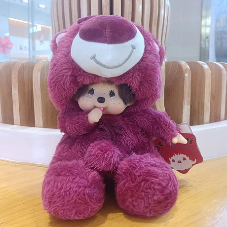 Plush toy in a purple outfit with a smiley face on a wooden surface