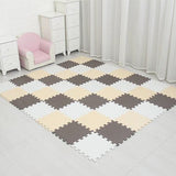 Checkered foam puzzle mat on a tiled floor with white furniture and curtains in the background.
