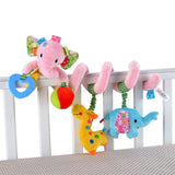 Colorful baby crib mobile with pink elephant, blue elephant, and yellow giraffe hanging from a white crib.