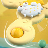 Toy resembling a cartoonish fried egg with a face on a yellow background