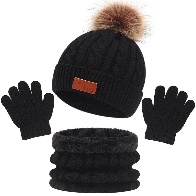 Black knit beanie with pom-pom, black gloves, and black knit scarf on a white background