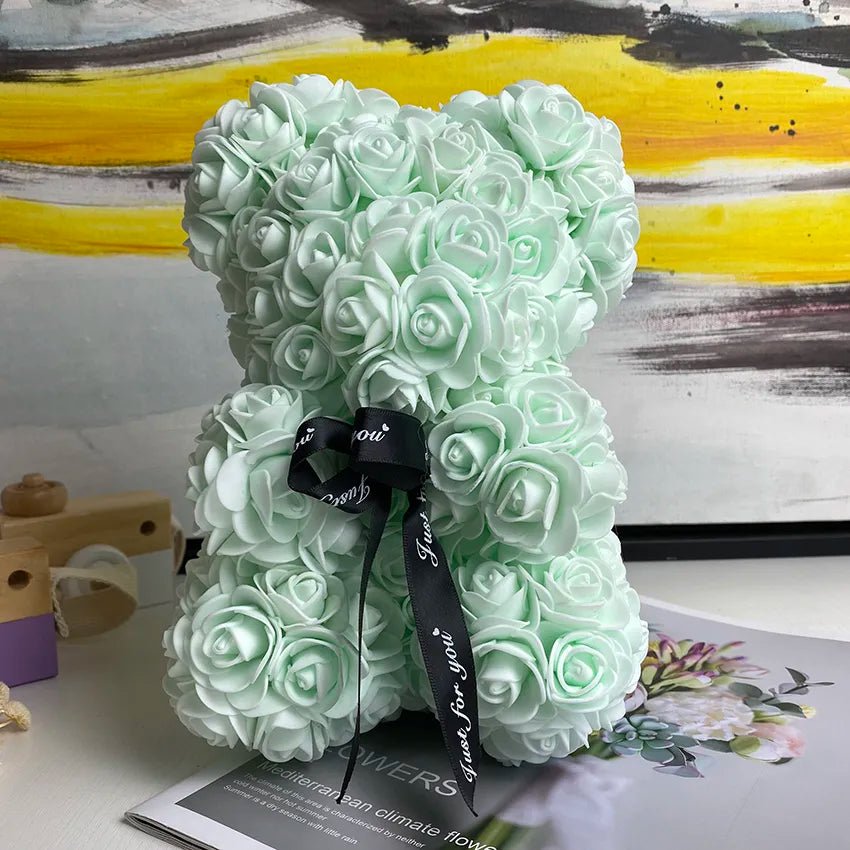 Mint green rose-shaped letter 'K' with a black ribbon.