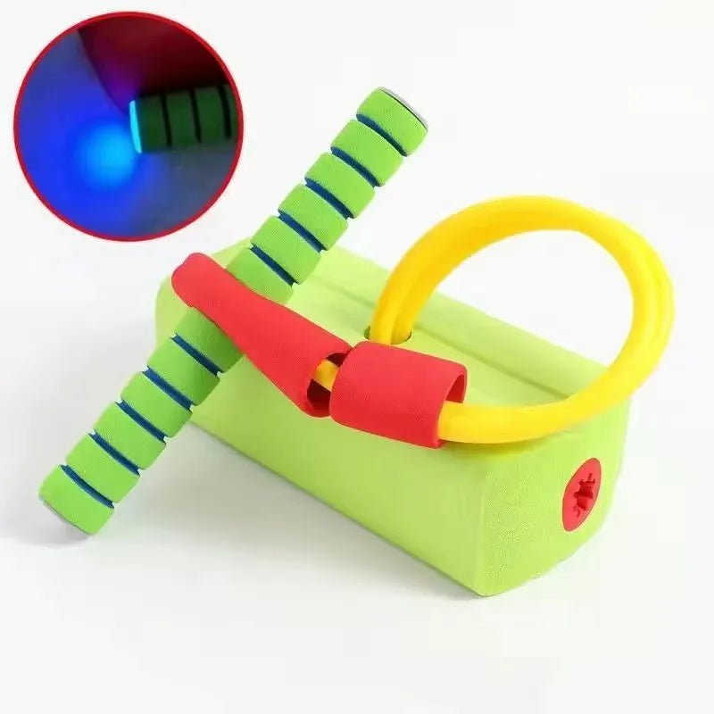 Colorful toy with a green body, red handle, and yellow ring on a white background.
