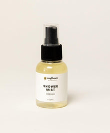 Bottle of morning shower mist steam booster with fresh citrus scent for daily wake-up shower routines.