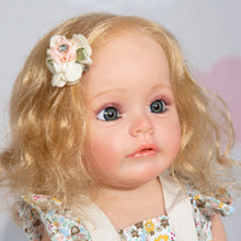 Full silicone Reborn Baby Doll 55cm with curly hair and floral headpiece close-up for collectors and doll photography.