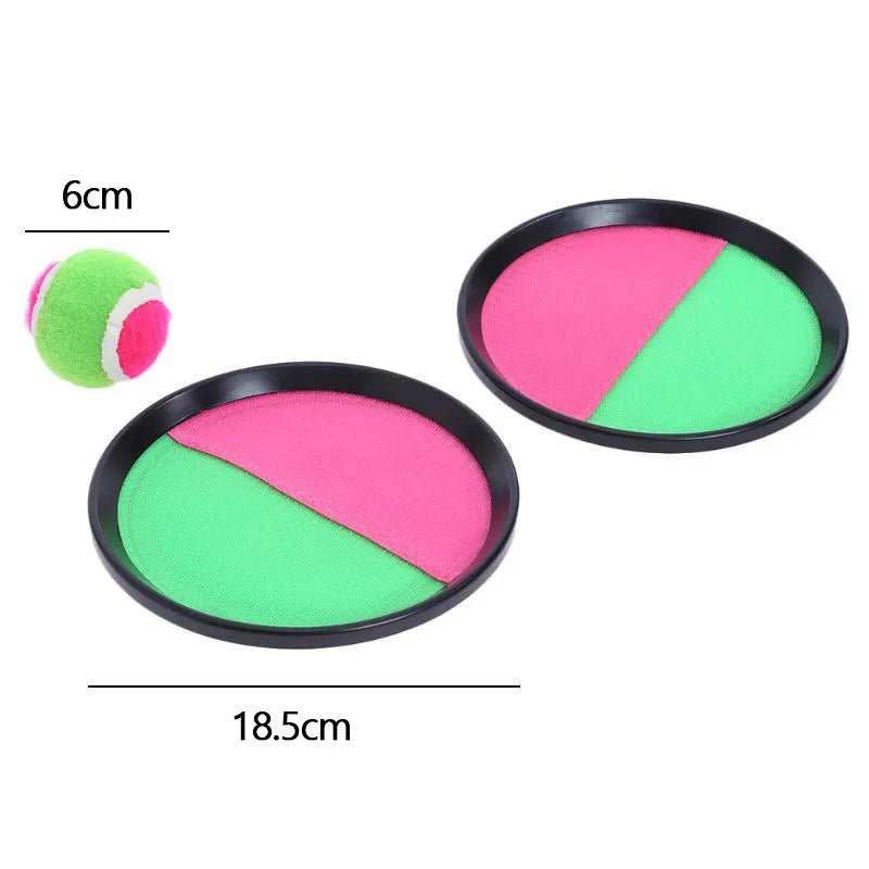 Two round objects with pink and green sections, one with a small ball.