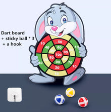 A dartboard with a cartoon character holding it, accompanied by three sticky balls and a hook. (option 2)