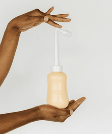 Close view of the gentle stream peri bottle nozzle designed for soothing perineal rinsing after childbirth.