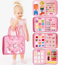 Pink Travel Busy Board held by a child for preschool learning, imaginative play, and calm restaurant waits.