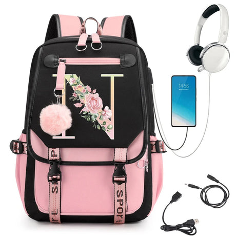 Pink and black backpack with floral design, phone, headphones, and USB cable.