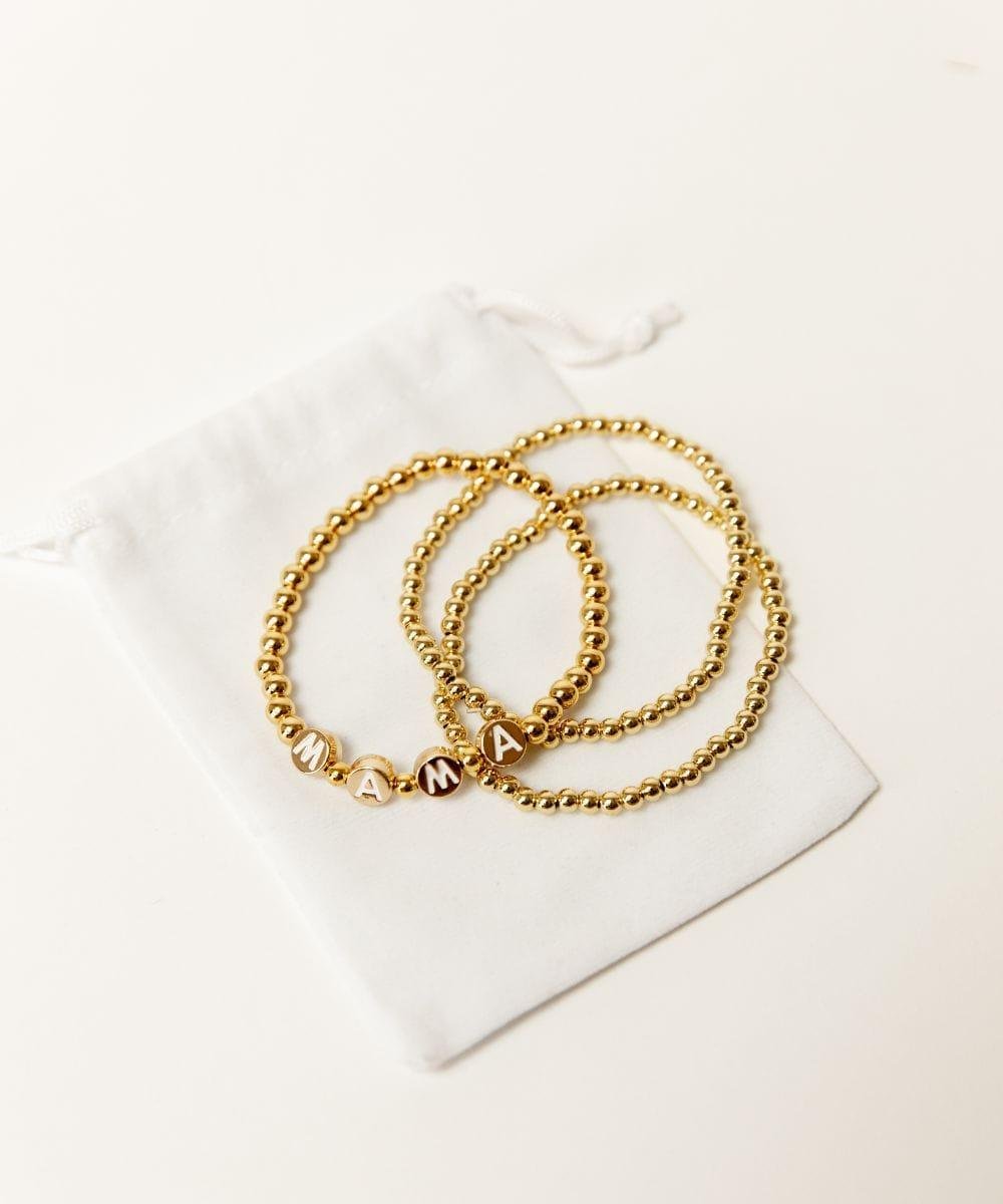 Three gold chain bracelets included in the First Pregnancy Bundle pack for a new mom gift.