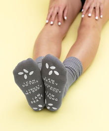 Gray motivational birthing affirmation socks worn for encouragement during labor and delivery.