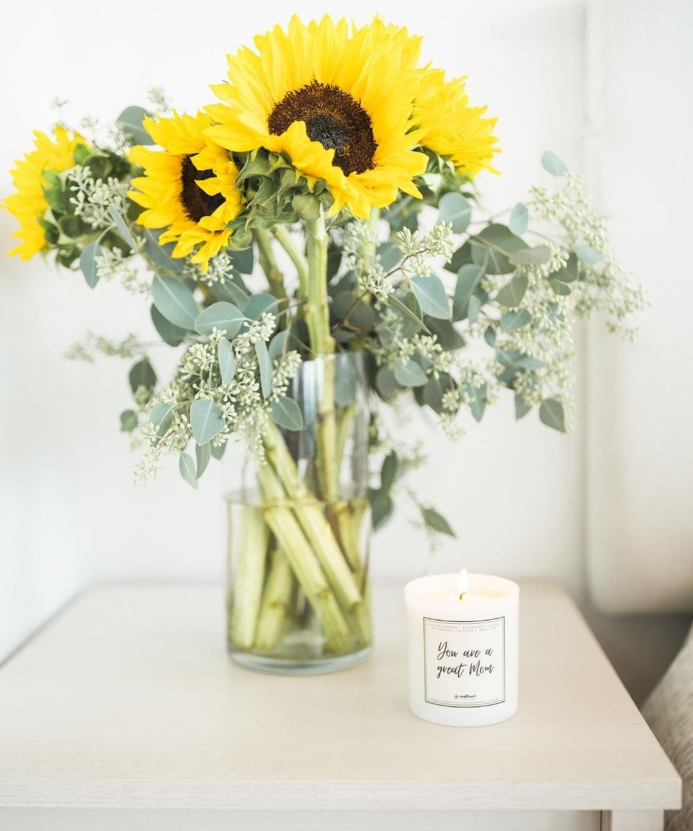 Vase with sunflowers and a candle