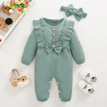 Green baby romper with bow headband and shoes flat lay for newborn gifting and daily dressing.