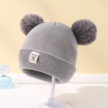 Grey Warm Knitted Baby Beanie with pom poms for neutral winter outfits and warm everyday baby dressing.