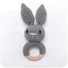 Grey bunny crochet baby rattle and teether ring, a handmade wooden toy that comforts babies through teething.