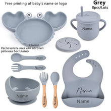 Grey crab baby feeding set with bowls, cups, and bibs, a complete weaning kit for messy first meals.