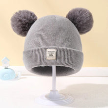 Grey Warm Knitted Baby Beanie with pom poms for autumn and winter warmth during nursery runs and walks.