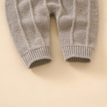 Grey knitted baby romper leg detail for a snug fit that stays put during crawling, naps, and play.