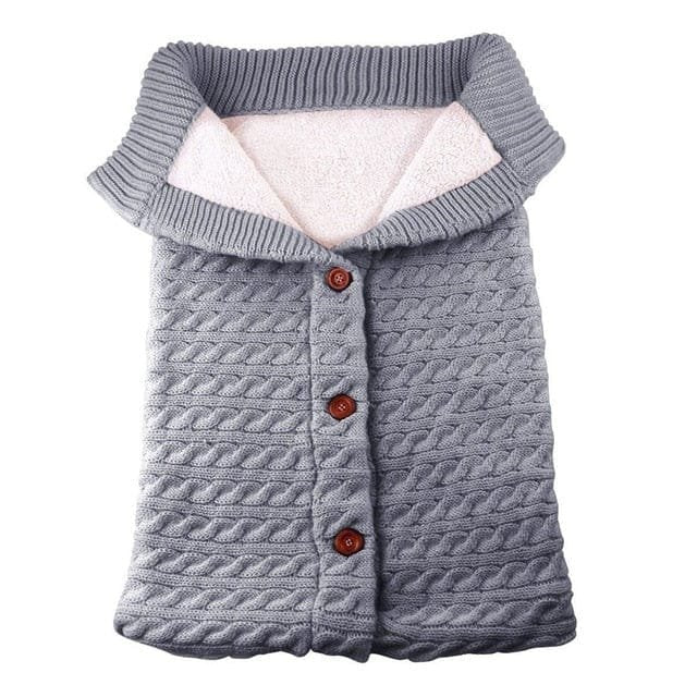 Grey knitted newborn sleep sack as a unisex baby sleeping bag for everyday naps and night sleep.