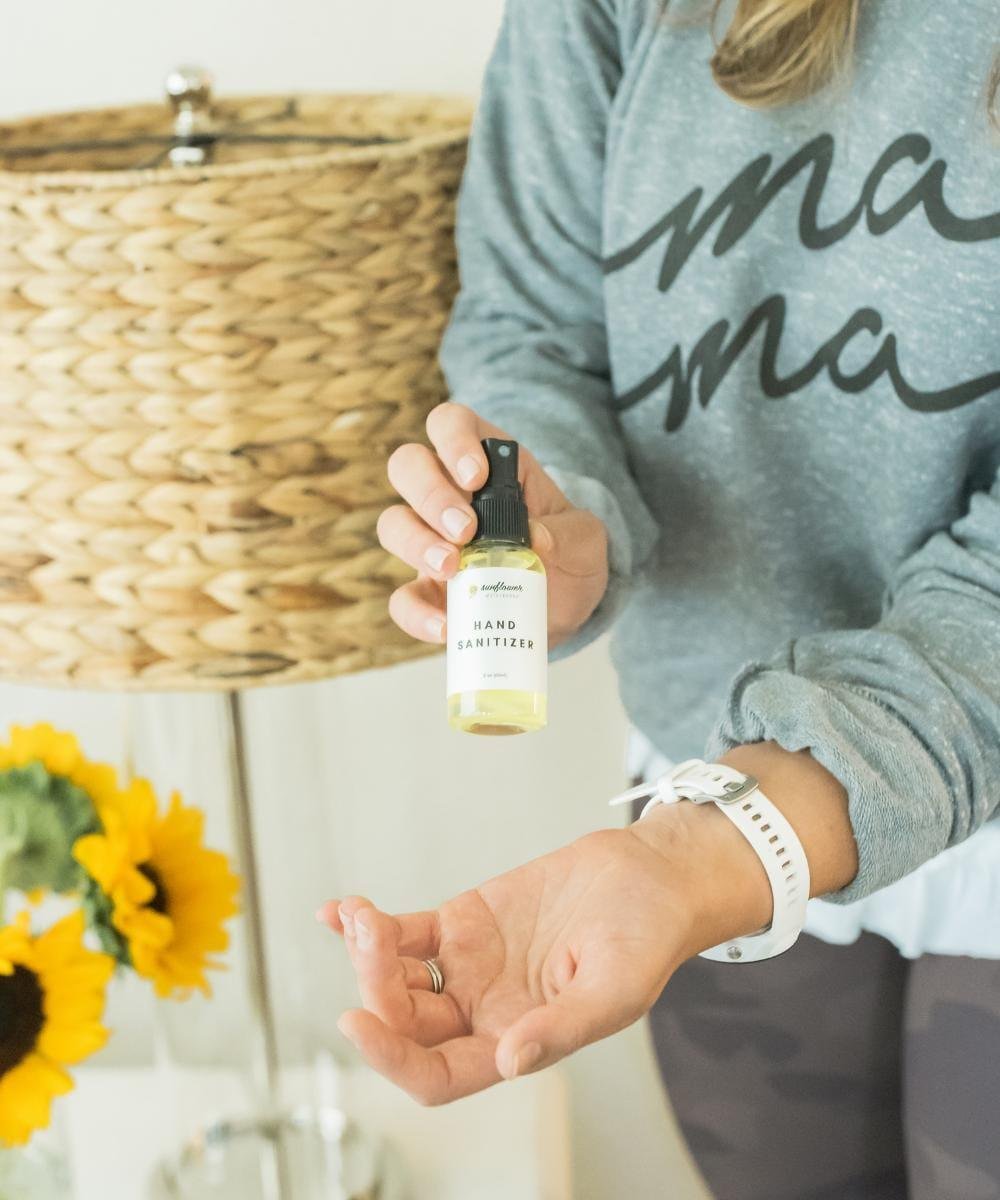 Person holding a small bottle of hand sanitizer