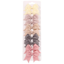 Rainbow colour handmade bow hair clips for matching girls outfits at school and parties.