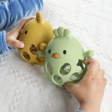 Baby hands holding olive and mango silicone chick teethers