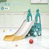 Children's slide with basketball hoop and balls on a light wooden floor.