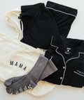 Hospital Comfort Bundle pajama set, socks, and mama shirt styled flat lay for hospital bag packing and postpartum recovery.