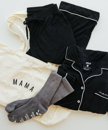 Hospital Comfort Bundle pajama set, socks, and mama shirt styled flat lay for hospital bag packing and postpartum recovery.