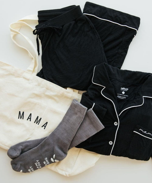 Black pajama set with white piping, gray socks, and a cream shirt with 'MAMA' text.