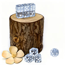 Transparent white-dot dice stacked on a tree stump beside a cream flower