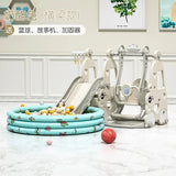 Children's playground equipment including a slide, swing set, and inflatable pool on a light-colored floor.