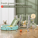 Children's play area with slide, swing set, and basketball hoop in a room.