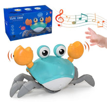 Induction escape crab musical toy shown with a toy box in the corner for scale reference.