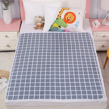 Grey grid print infant changing mat, a waterproof non-slip cover for cots, beds, and floor nappy changing stations.