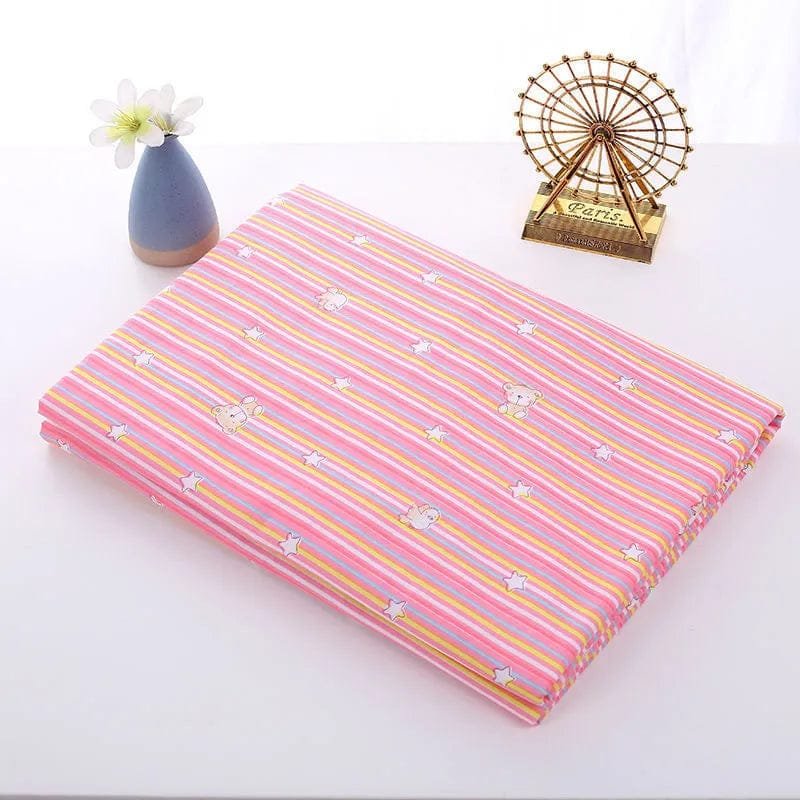Pink and yellow striped fabric with small white patterns