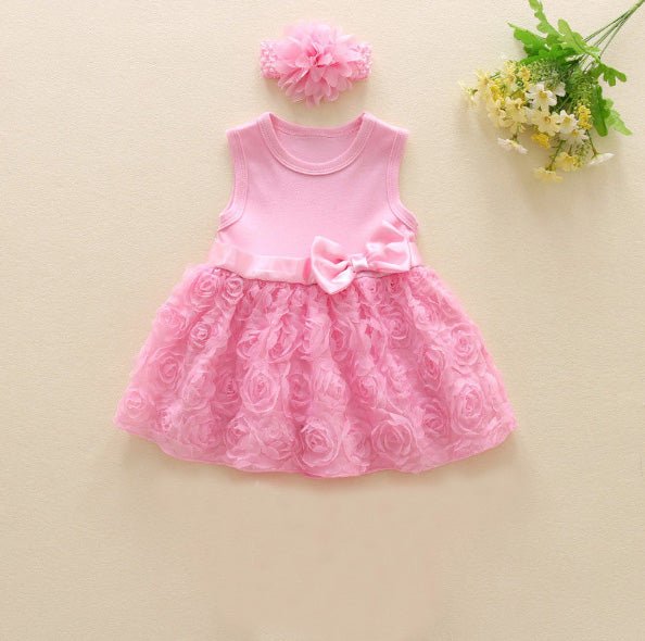Pink dress with floral details and a matching headband