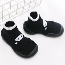 Black socks with white paw prints on a white background