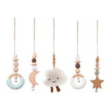 Set of hanging baby toys with clouds, moons, and stars.
