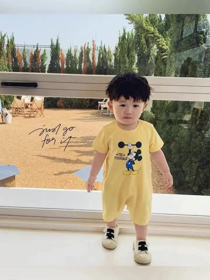 A child wearing a yellow outfit 