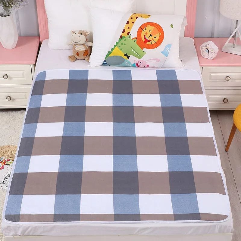 Checkered bedspread on a bed with colorful pillow and toys in a bedroom setting