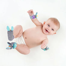 Infant wearing a rattle wristband and foot finder socks for sensory play that builds hand and foot awareness.